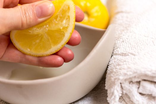 Pressed lemon in wellness by a hand