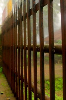 An old rusty iron fence made for security of a villa.