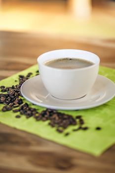 An image of a cup of coffee with beans