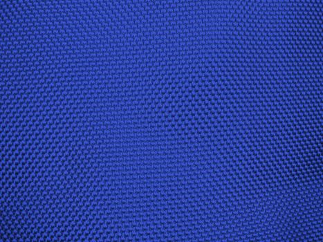 Knit woolen texture. Fabric blue background