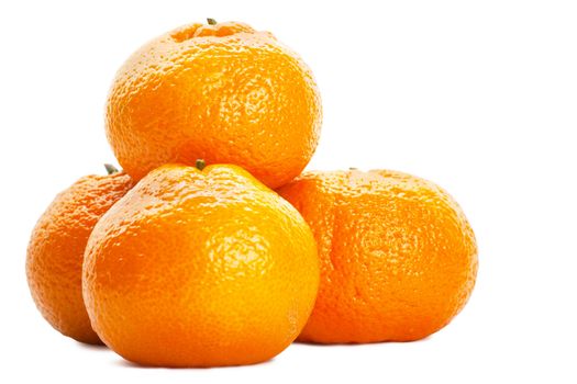 A heap of fresh orange tangerines isolated over white background