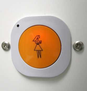 orange button in a hostpital to call the nurse for assistance