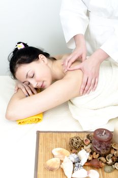 Young lady receiving back massage at spa center