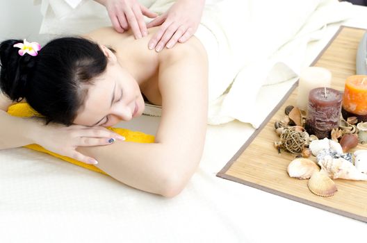 Young lady receiving back massage at spa center