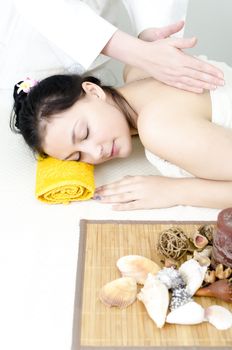 Young lady receiving back massage at spa center