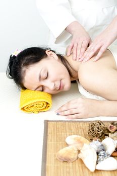 Young lady receiving back massage at spa center
