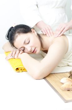Young lady receiving back massage at spa center