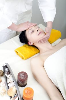 Young lady receiving face massage at spa center