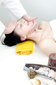 Young lady receiving face massage at spa center
