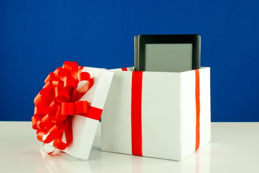 Electronic book reader in a box against blue background