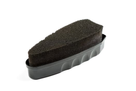 Black sponge for cleaning footwear isolated on white background.