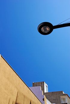 Street light and building roof. Lloret de Mar, Spain.