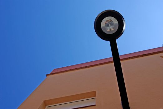 Abstract forms. Street light and building corner. Lloret de Mar, Spain.