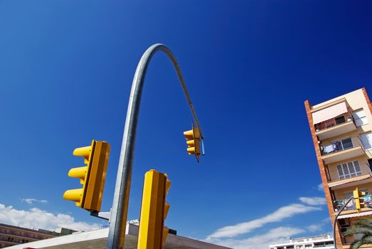 Curve composition with yellow street-traffic control lights. Lloret de Mar, Spain.