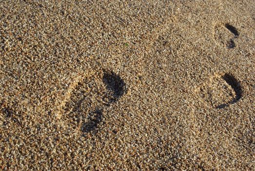 Foot prints on the mediterranean beach. Sunset time. As backdrop or background.