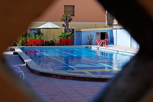 Natural framed photo of hotel pool in Spain.