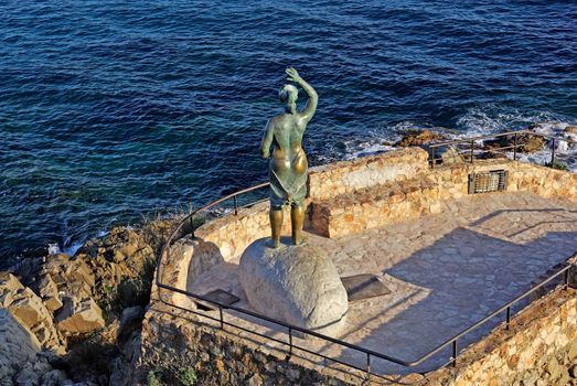 Bronze statue of woman looking to the sea. Lloret de Mar, Costa Brava, Spain.