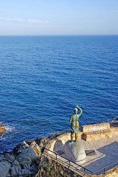 Bronze statue of woman looking to the sea. Lloret de Mar, Costa Brava, Spain.