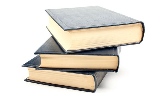 Three old books with yellowed pages isolated on white background.