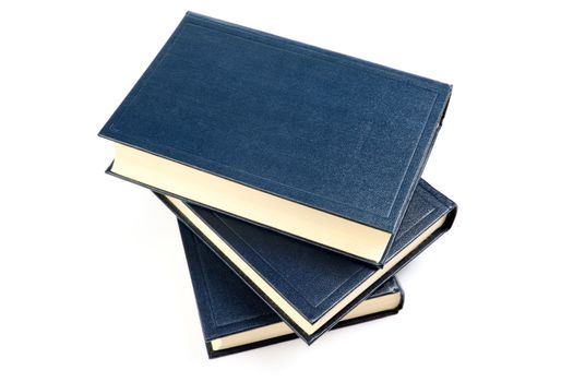 Three old books with yellowed pages isolated on white background.