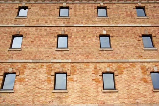 Brick wall with windows as background or backdrop.