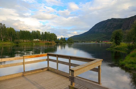 Pier on lake in Norway before sunset, Scandinavian Europe.