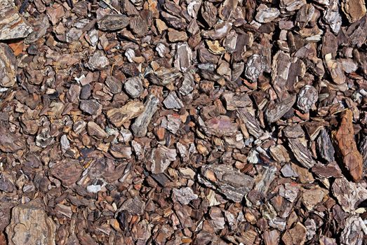 Shredded brown bark as decoration for garden. Good as background or backdrop.