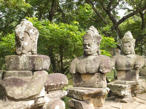 The ancient stone statue of Khmer god on the south gate of Angkor Thom, the world heritage site in Siem Reap province, Cambodia