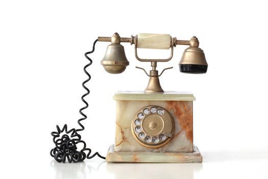 isolated  vintage telephone made of marble with its reflection