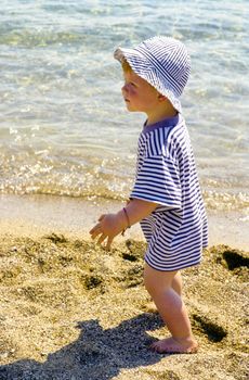 cute young child boy enjoys the beach