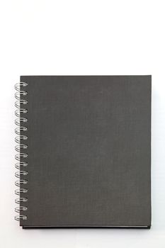 isolated black hard cover notebook with ring binder on white