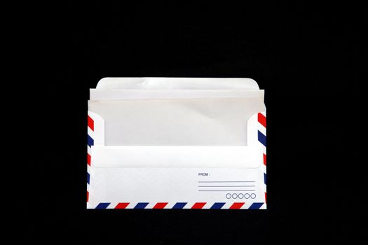 isolated airmail Envelope with blank vintage paper on black background.