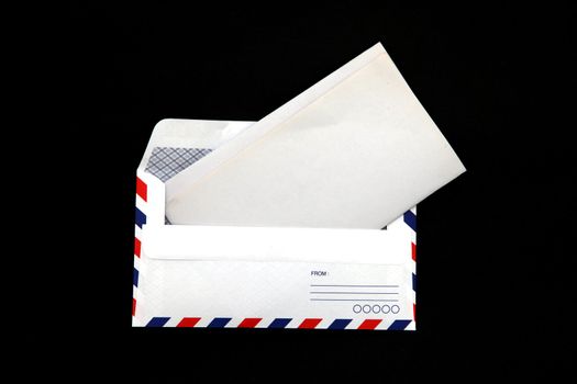 perspective of isolated airmail Envelope with blank vintage paper on black background.