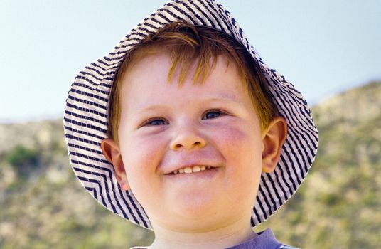 cute young child boy enjoys the beach