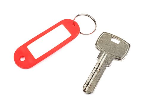 Key and red trinket with empty for your design space isolated on white background.