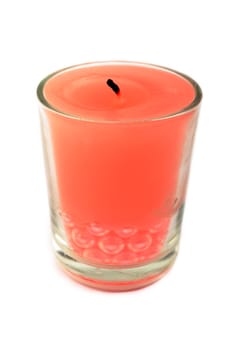 Red candle in glass isolated on white background.