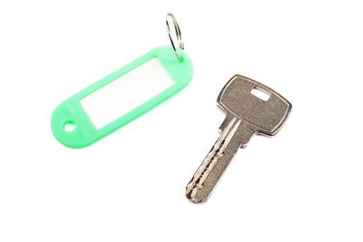 Key and green trinket with empty for your design space isolated on white background.