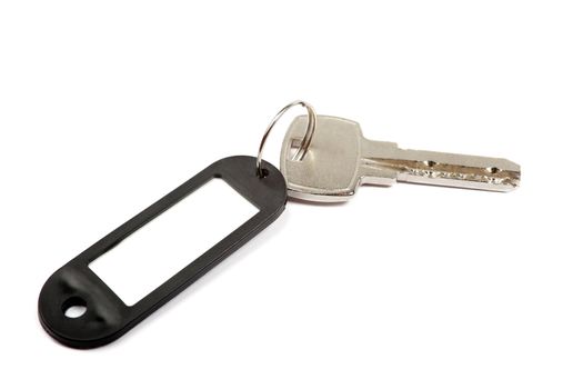 Key and black trinket with empty for your design space isolated on white background.
