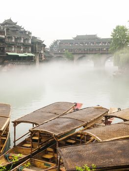 Wooden boat on Tuojiang river in Fenghuang county, Hunan, China.