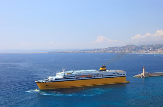 Big yellow cruise ship in port of the city of Nice.