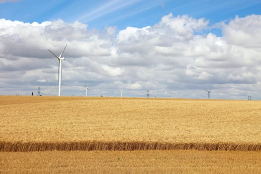 French field with wind power generators, Europe.