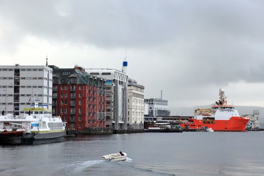 Industrial view of norwegian harbor of Bergen. Cloudy scandinavian weather in summer.