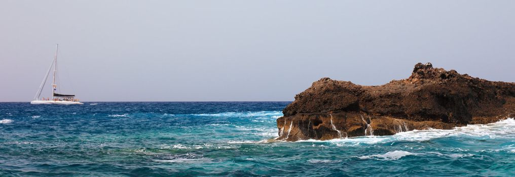 Panoramic view of sailing boat and rock near Tenerife, Canary Islands.