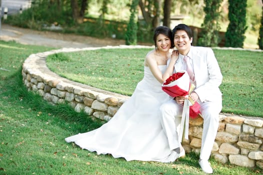 couples of bride and groom on green meadows