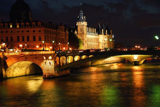 Bridges over Seine and Conciege in nighttime Paris France