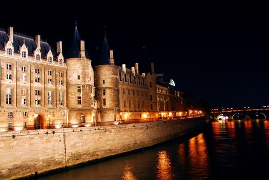 Bridges over Seine and Conciege in nighttime Paris France