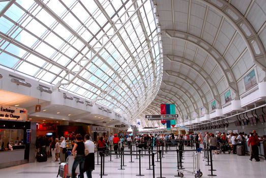Passengers lining up at check-in counter at the modern international airport