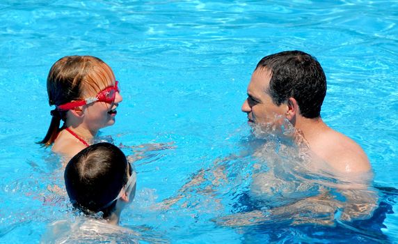 Family having fun in swimming pool