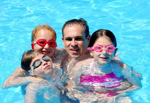 Family having fun in swimming pool