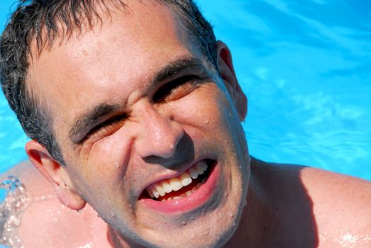 Portrait of a laughing man in a swimming pool